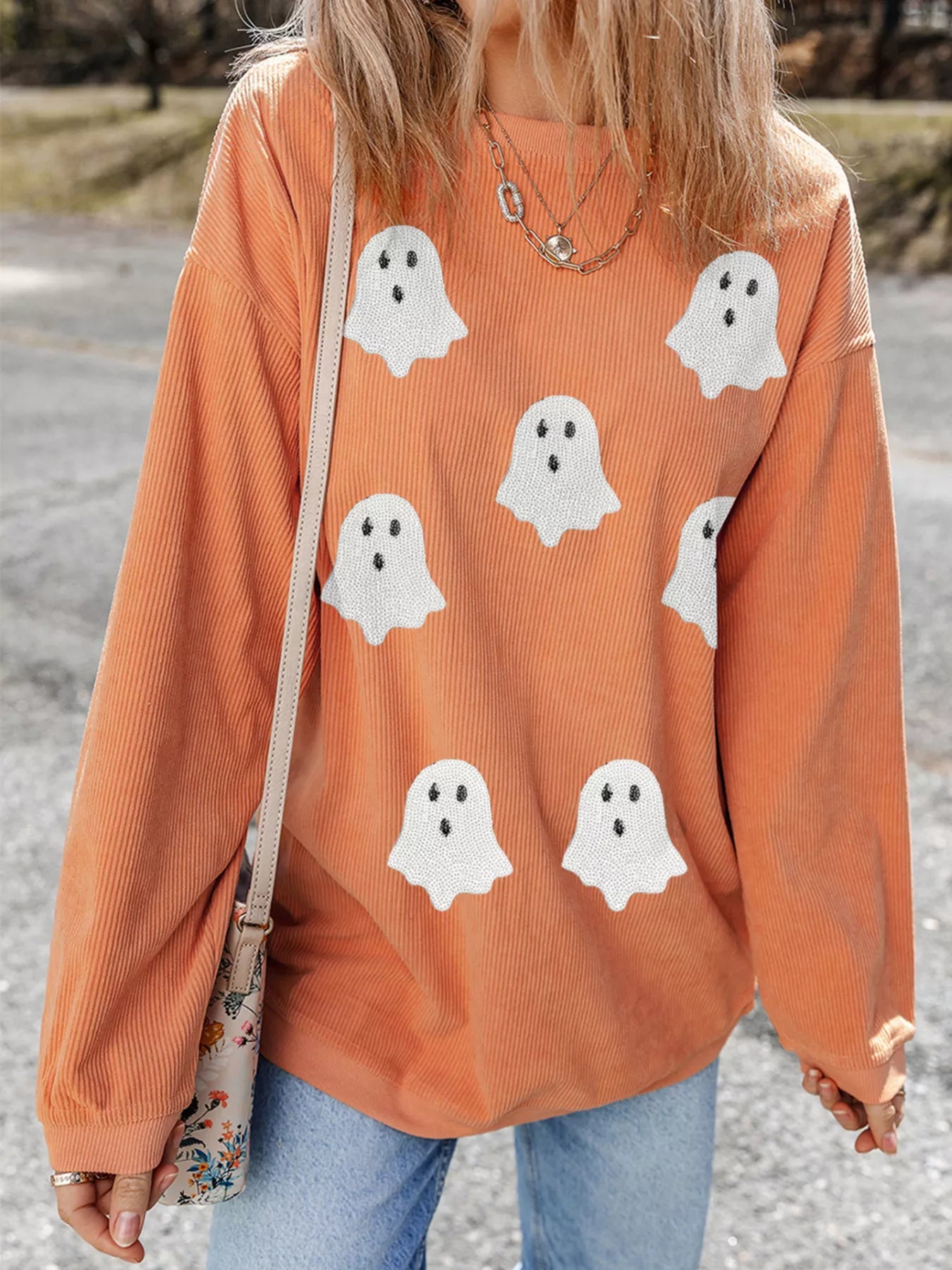 Woman wearing Halloween Ghost Sweatshirt with sequin ghost design
